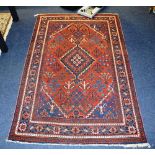 An antique Persian Jashagan rug, the central medallion over red ground,