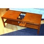 A retro 1960's coffee table by Myer, with open magazine compartment to top above undertier,