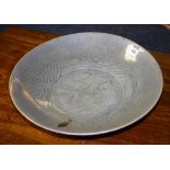 A Chinese celadon glazed pottery dish, of circular form with foliate decoration, 34cm diameter