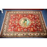 An Eastern rug, the central medallion over red ground with exotic animals and floral decorations and