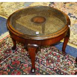 A mahogany coffee table, of circular form with bergere woven cane inset and glass top,
