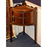 A George III mahogany bow front corner cupboard, with shaped gallery and panelled door,