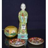 A Chinese glazed pottery figure of a monk holding vase, in green glazed floral gown, 23cm high,