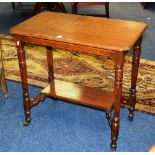 An oak occasional table, the rectangular top raised on turned and reeded supports, with undertier,