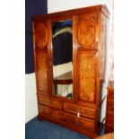 A late Victorian walnut wardrobe, with moulded cornice above central glazed door,