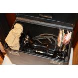 A vintage portable singer sewing machine, with accessories, in fitted carry case CONDITION REPORT: