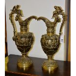 A pair of neo classical style brass garniture jugs,