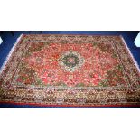 A Kashan style carpet, the central medallion over red ground,