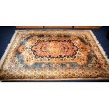 An Indian rug, the central peach medallion over cream and blue ground,