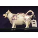 A 19th century Staffordshire cow creamer with cover,