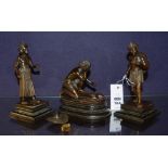 Three Oriental bronze figures, modelled as males in working poses, raised on wood plinths,