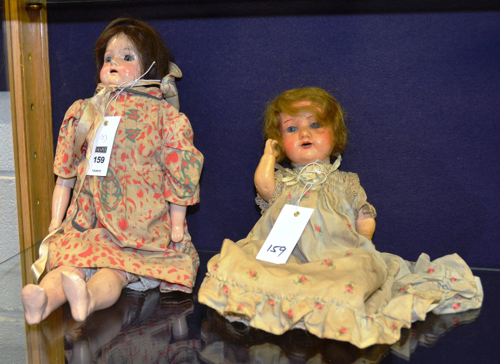 Two German bisque headed dolls, both in traditional dress and under garments,