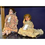 Two German bisque headed dolls, both in traditional dress and under garments,