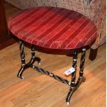 A Victorian ebonised and gilt side table, the oval top on fluted spiral turned legs,