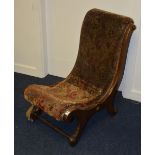 A Victorian mahogany S-shaped nursing chair, with cushioned seat and back,