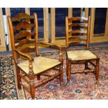 A harlequin set of eight Lancashire oak dining chairs, with ladder backs, rush seats,