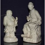 Two Chinese blank de chine figures, in the form of a Buddha and man with writing slate, 21 & 25cm