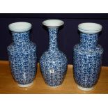 Three matching Chinese porcelain vases, with blue foliate decoration on white ground, blue reign