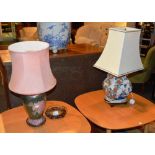 Two Oriental pottery table lamps with shades, both with foliate decoration,