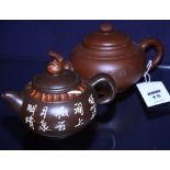 Two small Chinese earthenware saki teapots, of bullet shape, both with reign marks to base,