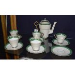 A Foley china Art Deco coffee set, decorated with silver lustre and green border, on white ground,