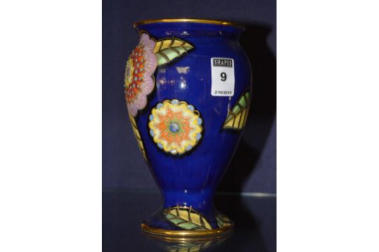 A Carlton Ware Medley vase, decorated with floral enamels on blue ground, pattern no. 3601, 18cm