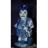 A Delft style toby jug of Town Crier, glazed in blue on white ground, France marked to underside,