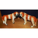 A pair of Boness pottery St Bernard dog figures, with amber glass eyes,