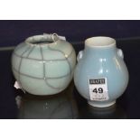 Two Chinese glazed pottery spill vases, the blue glazed vase of baluster form, with moulded monkey