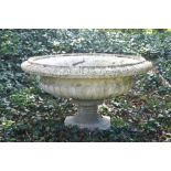 Large reconstituted stone jardiniere of circular form with egg and dart moulded border, above a