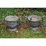 Pair of eighteenth-century period lead urns 54 cm. wide; 34 cm. highof vase shape each with scroll