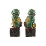 Pair of Chinese nineteenth-century polychrome Foo dogs Each seated on its hind legs with one paw