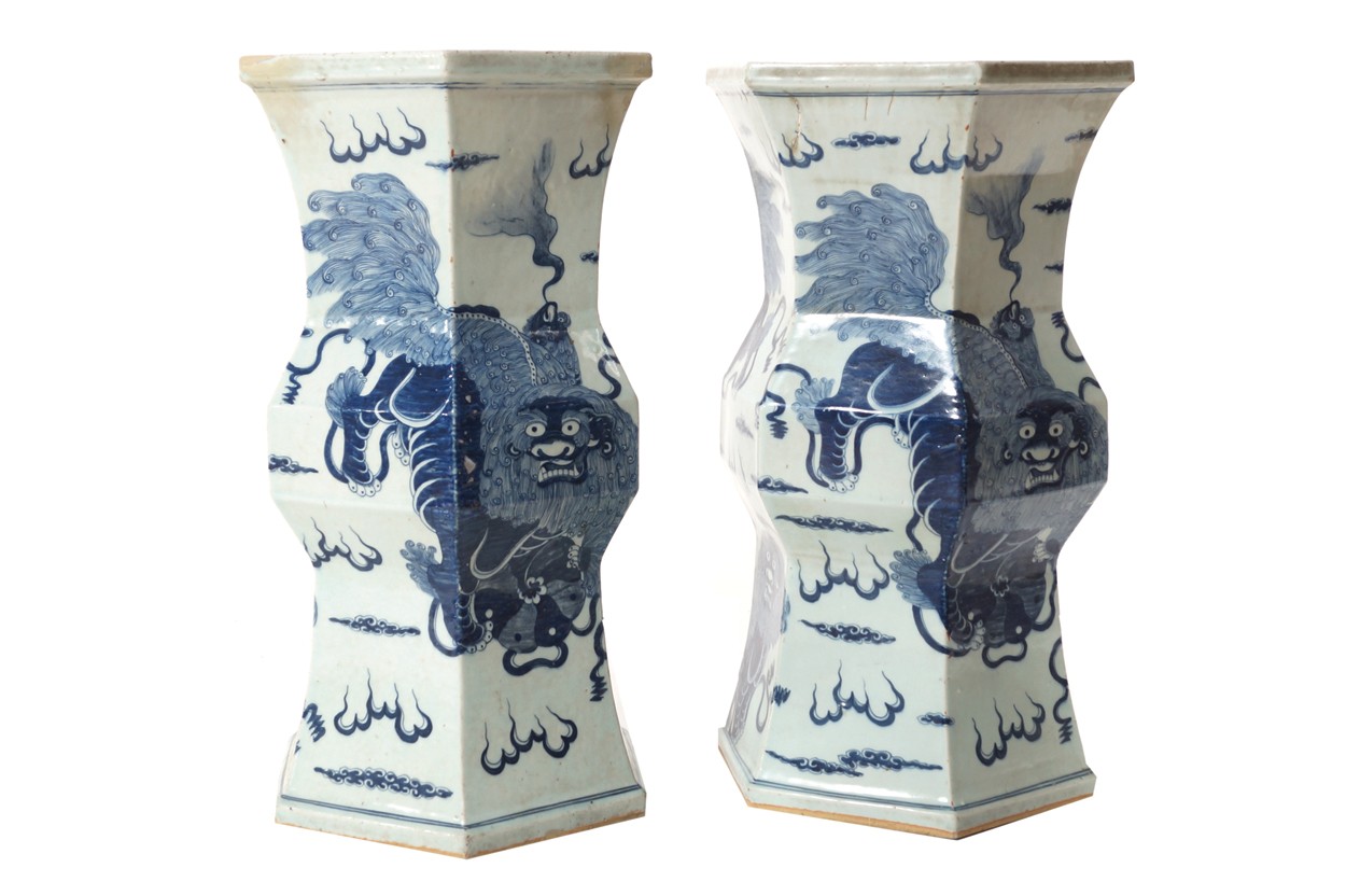 Pair of early twentieth-century Chinese blue and white pedestals each decorated with kilin amongst