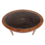 Nineteenth-century mahogany low table the oval shaped tooled leather inset top, above a conforming