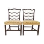 Pair of nineteenth-century mahogany ladder back dining chairs each with an upholstered stuff over