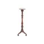 Edwardian period mahogany torchere the leaf carved and spiral turned pillar raised on a scroll pod