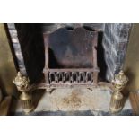NINETEENTH-CENTURY ORMOLU AND CAST-IRON FIRE BASKET with a C-scroll apron, fronted by classical urns