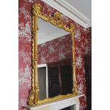NINETEENTH-CENTURY GILT-FRAMED OVER MANTLE MIRROR the rectangular plate with a serpentine top and