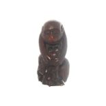 NINETEENTH-CENTURY BLACK FOREST CARVING of a monkey holding a bunch of nuts Direct all shipping