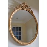 LARGE  NINETEENTH-CENTURY GILT FRAMED MIRROR the oval bevelled plate within a guilloche moulded