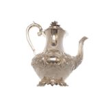 CRESTED ROCOCO SILVER COFFEE POT with leaf embossed decoration framing an armorial cartouche on