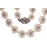 ﻿AN IMPORTANT STRING OF SOUTH SEA CULTURED PEARLS ﻿with an oval clasp, set with round brilliant