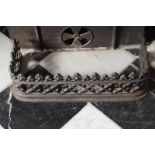 SMALL ORNATE CAST-IRON FENDER Direct all shipping enquiries to shipping@sheppards.ie 53 cm. wide; 16