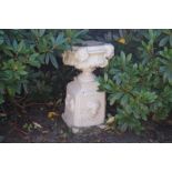﻿RECONSTITUTED STONE URN ON STAND ﻿with mask decoration, the ribbed bowl raised on a turned stem,