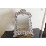 SILVER AND VELVET FRAMED VANITY MIRROR the rectangular bevelled plate with serpentine corners within