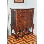 EIGHTEENTH-CENTURY OAK CHEST ON STAND of two short and three long drawers, furnished with brass