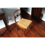 PAIR OF REGENCY SCROLL BACK SIDE CHAIRS each with a drop-in seat , raised on sabre legs to the