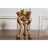 GILT BRONZE CANDLESTICK  raised on cherub headed scroll legs, terminating on taloned claw and ball