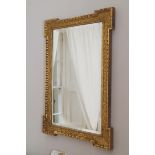 NINETEENTH-CENTURY CARVED GILTWOOD FRAMED MIRROR the rectangular bevelled plate within a leaf carved