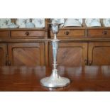 SILVER CANDLESTICK of oval turned and fluted form raised on a paterae moulded oval foot, London 1924